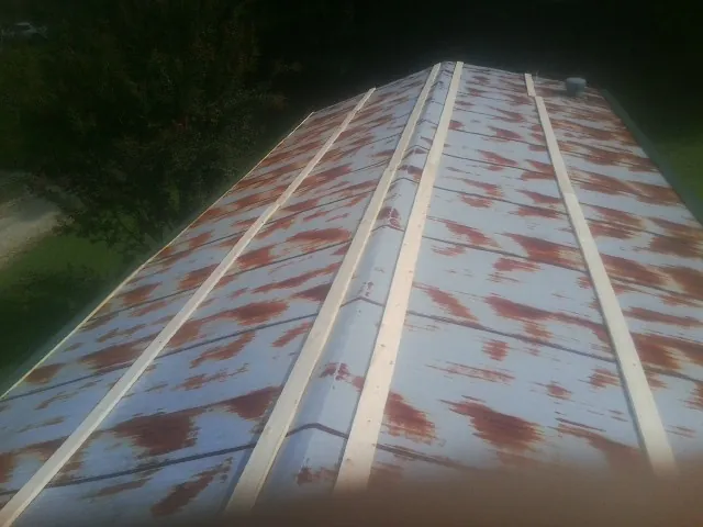 Rusted metal roof panels with new wood purlins before replacement — Storm Damage Roof Repair in Bonnieville by Roofing Brothers