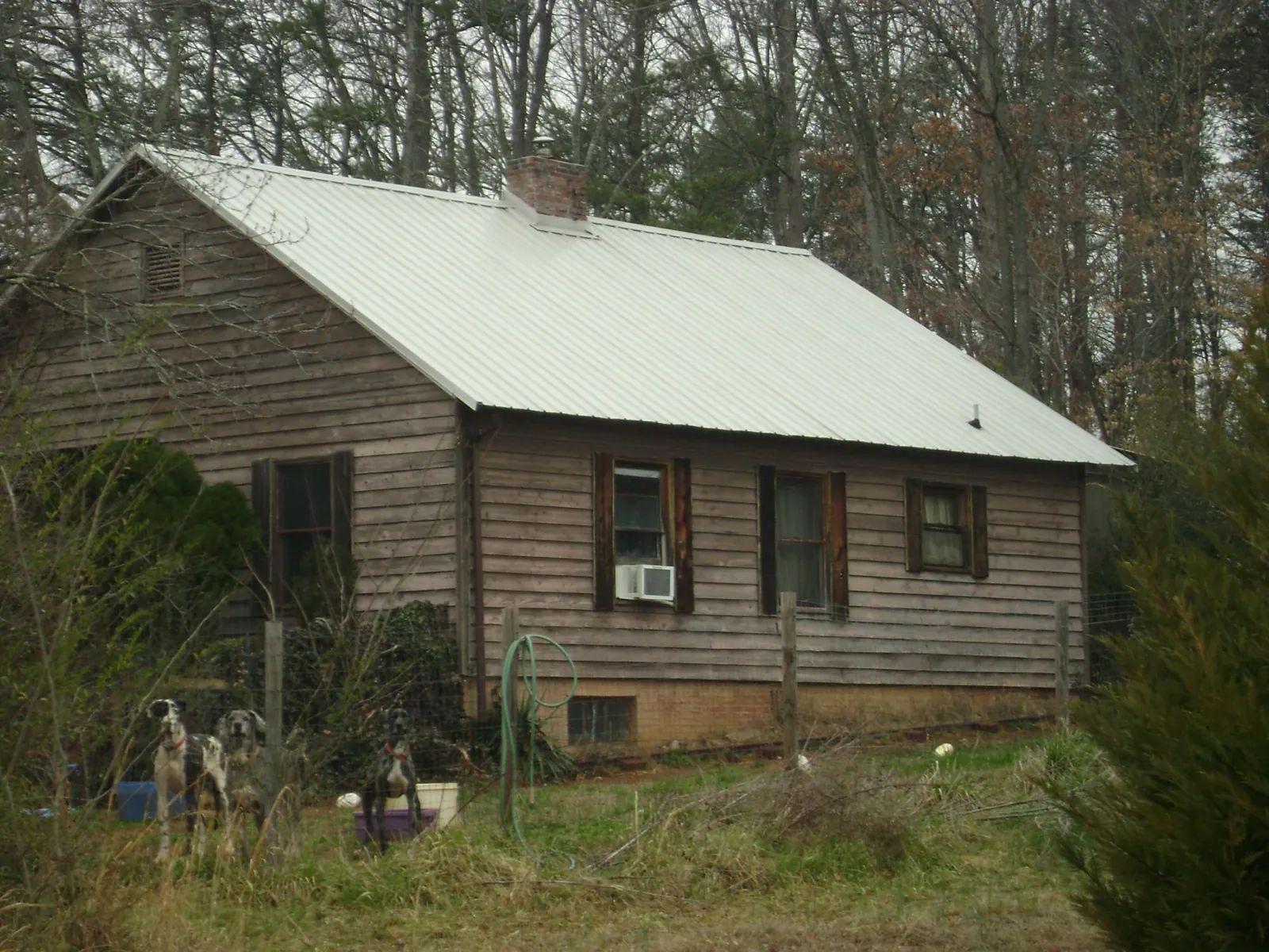 White metal roof on an old wood sided farmhouse, from a Metal Roof Installation job in Bonnieville